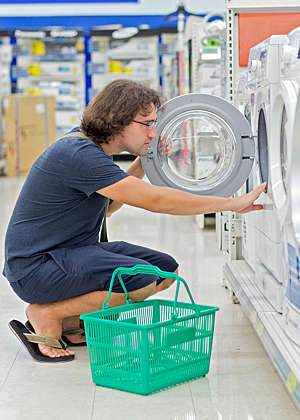 Man shopping for a combo washer-dryer.