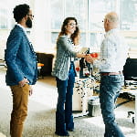 Businesswoman shaking hands with client before a meeting. 