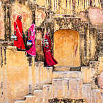 Indian women carrying water from stepwell near Jaipur.